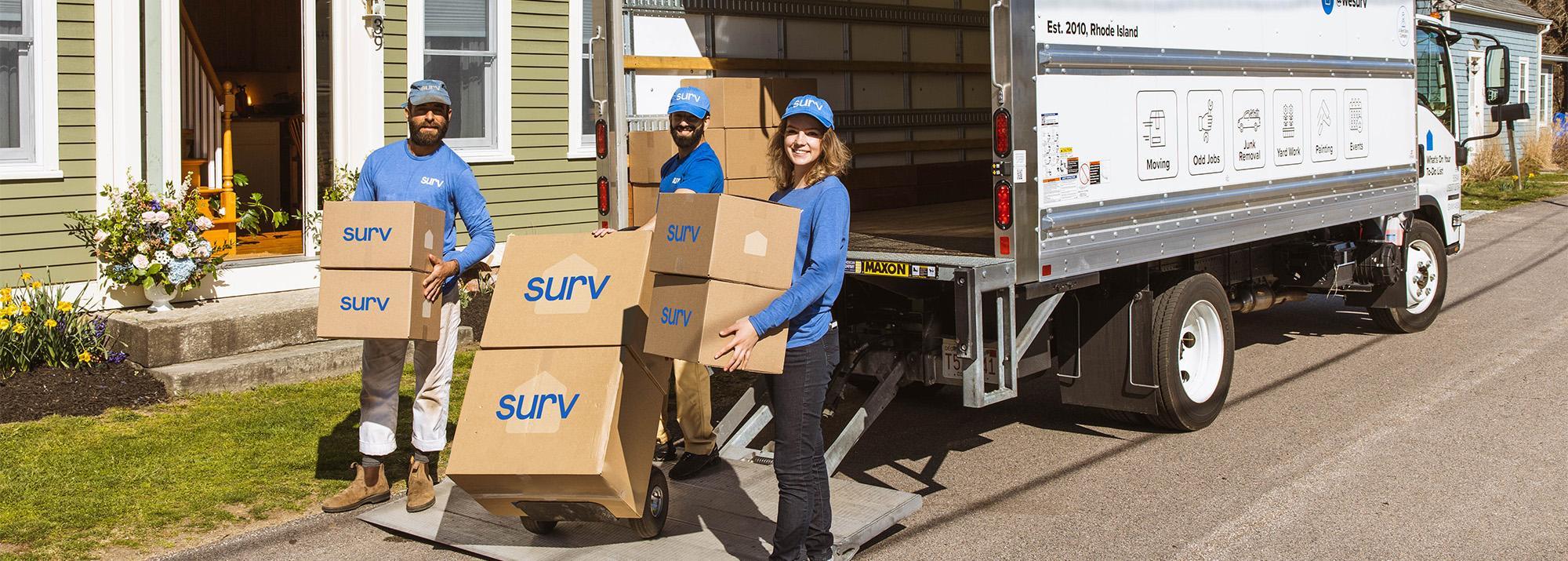 three people with moving boxes