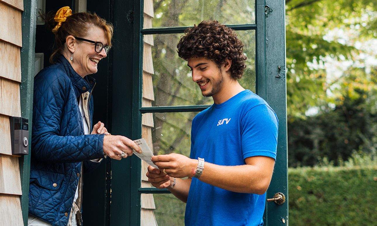 A Surv employee assisting a woman