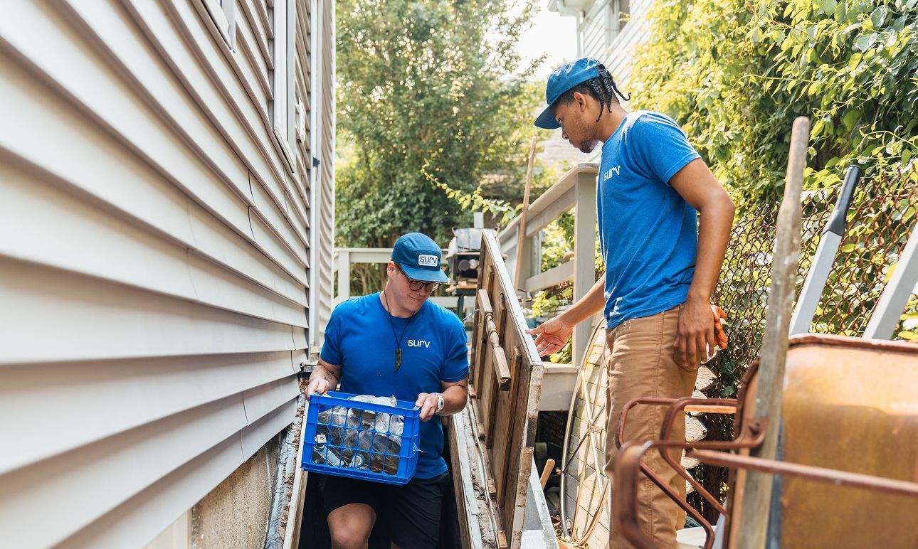 Two Surv workers hauling away junk