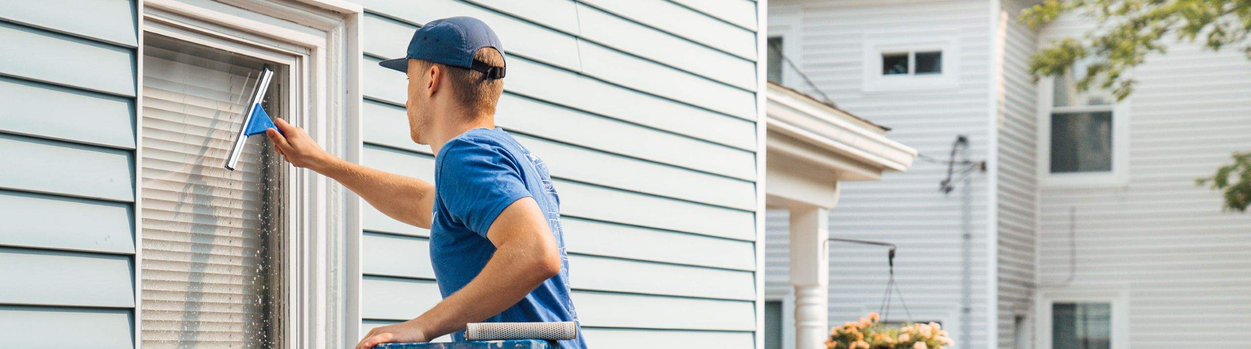 A Surv worker cleaning a window