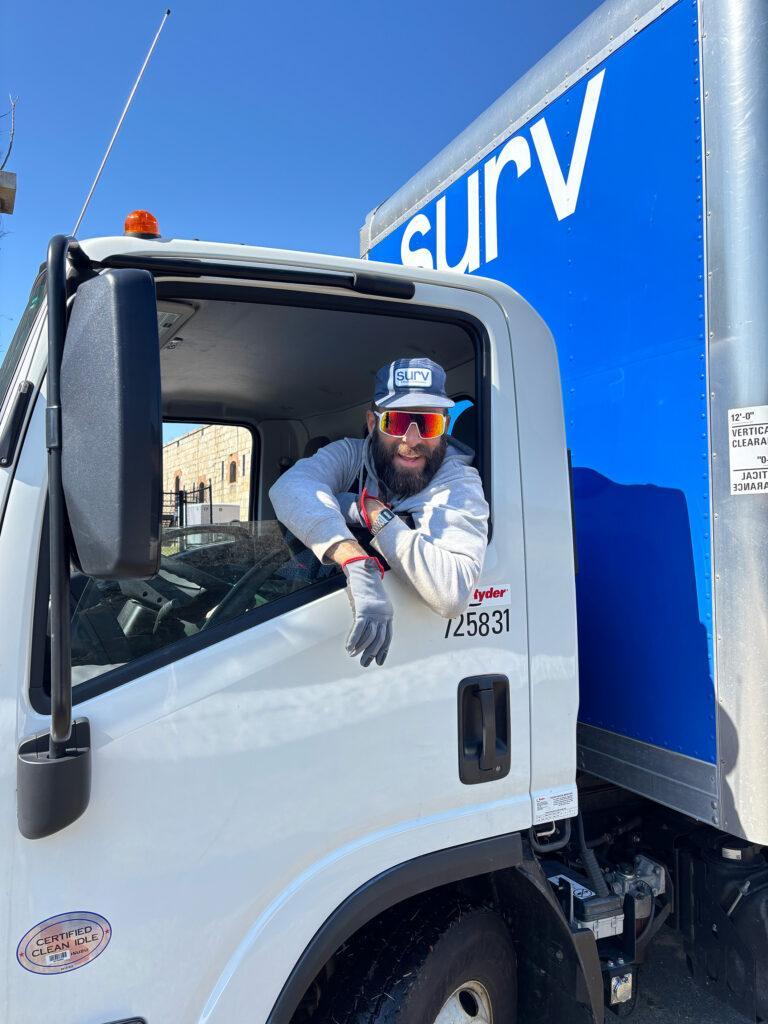 A Surv Worker in a moving truck