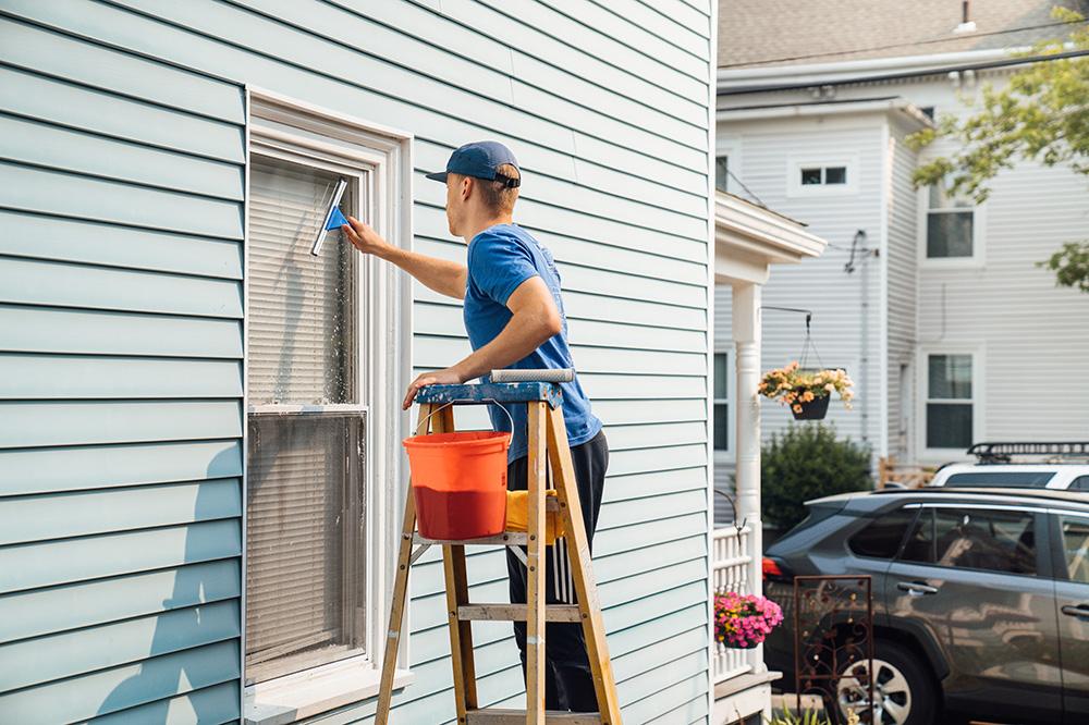 Surv Local Worker Washing a Window