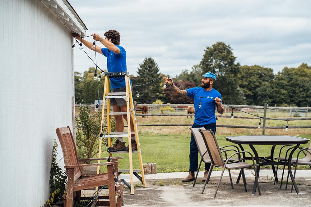 Surv workers hanging patio lights