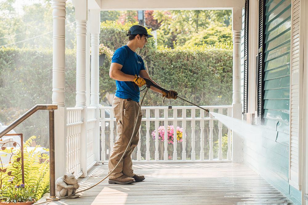 Surv Working cleaning a home's exterior