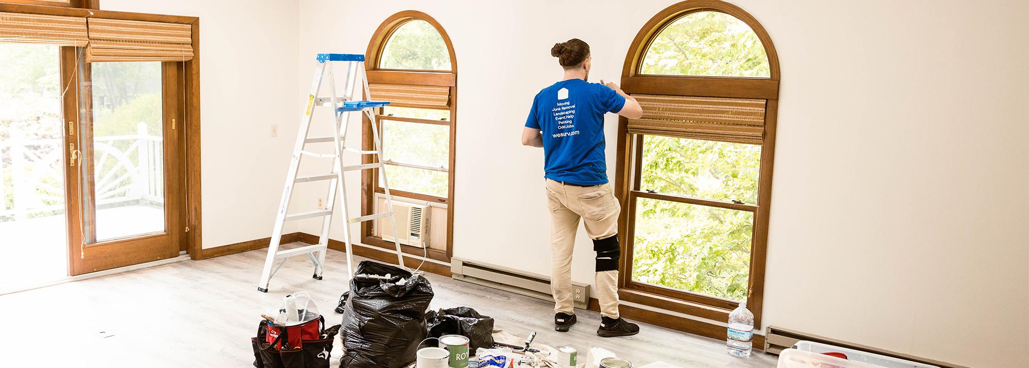 Surv Worker painting a living room
