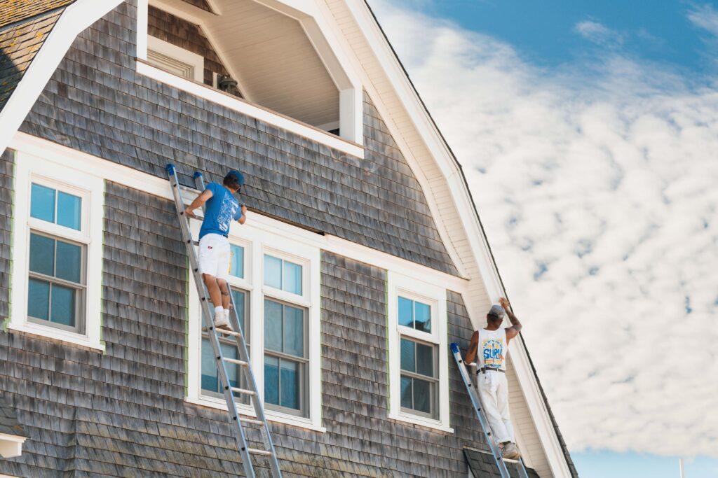 Surv workers painting a house