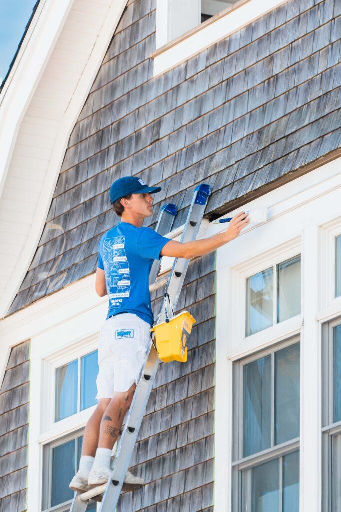 Surv workers painting a house