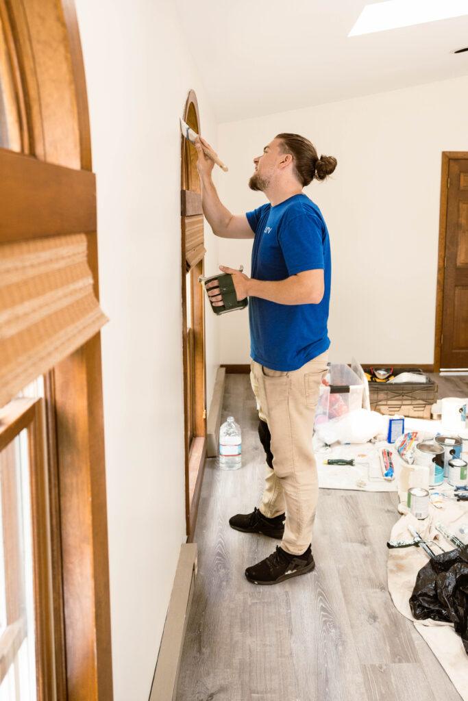 Surv workers painting a living room
