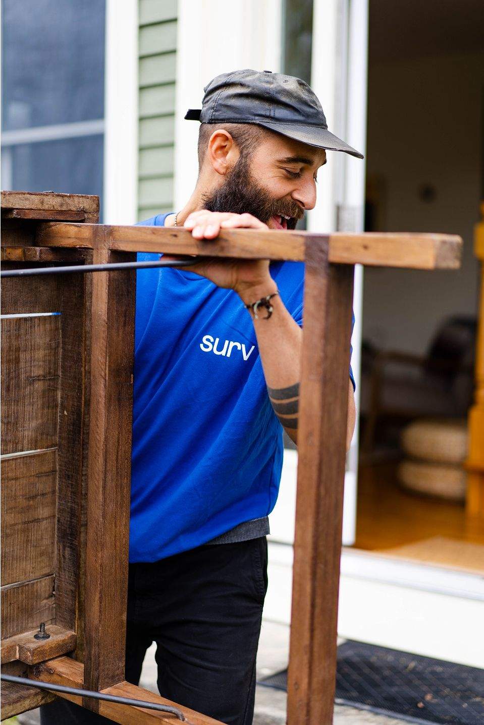 A man carrying a piece of furniture
