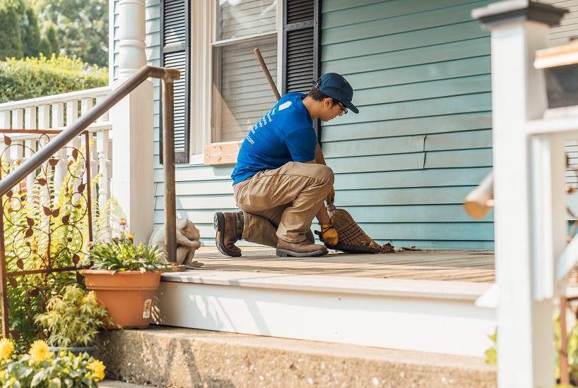 Sweeping a dirty front porch