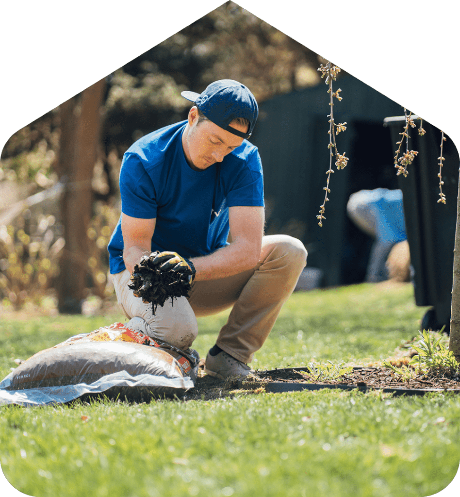 A Surv employee putting down mulch
