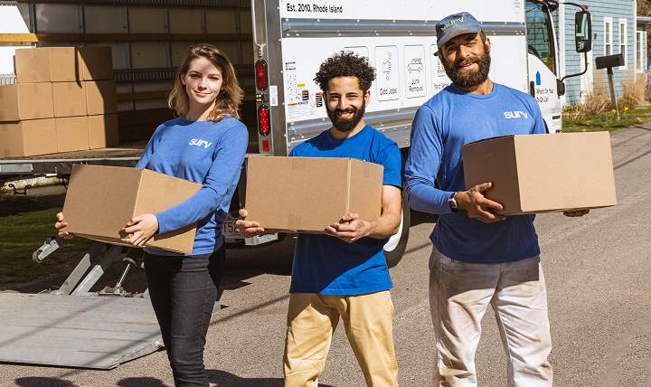 Three Surv workers moving boxes