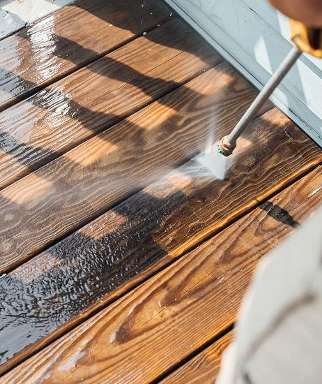 Power washing a wooden deck