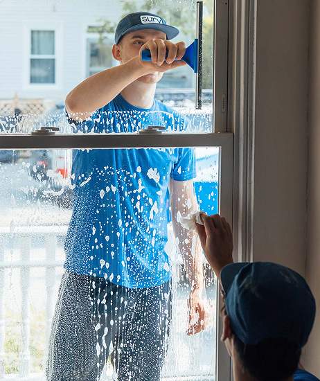 Cleaning a window with a squeegee