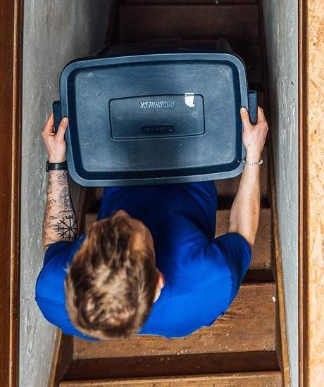 Carrying a container up a flight of stairs