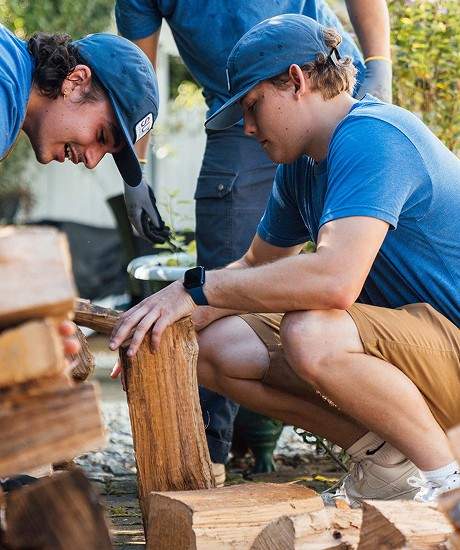 A crew splitting wood